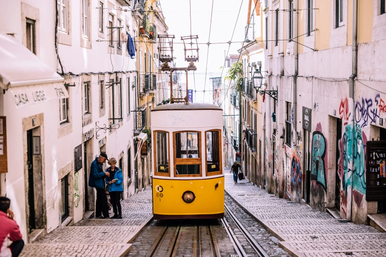 a yellow trolly going through some old town