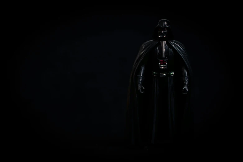 a star wars character standing in a dark space