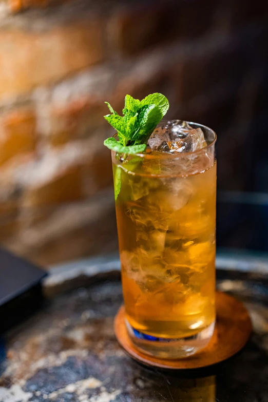 a cocktail drink is sitting on the top of a barrel