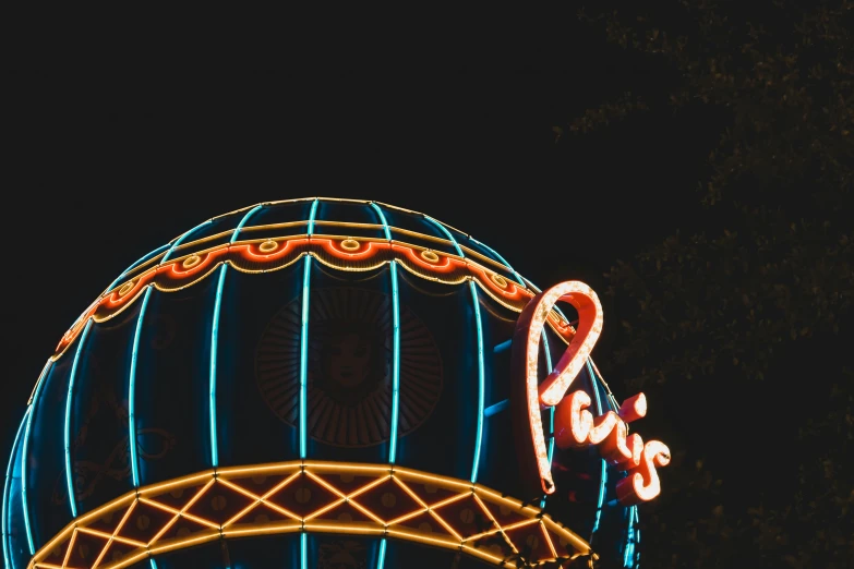 the neon lights on a carnival ride at night