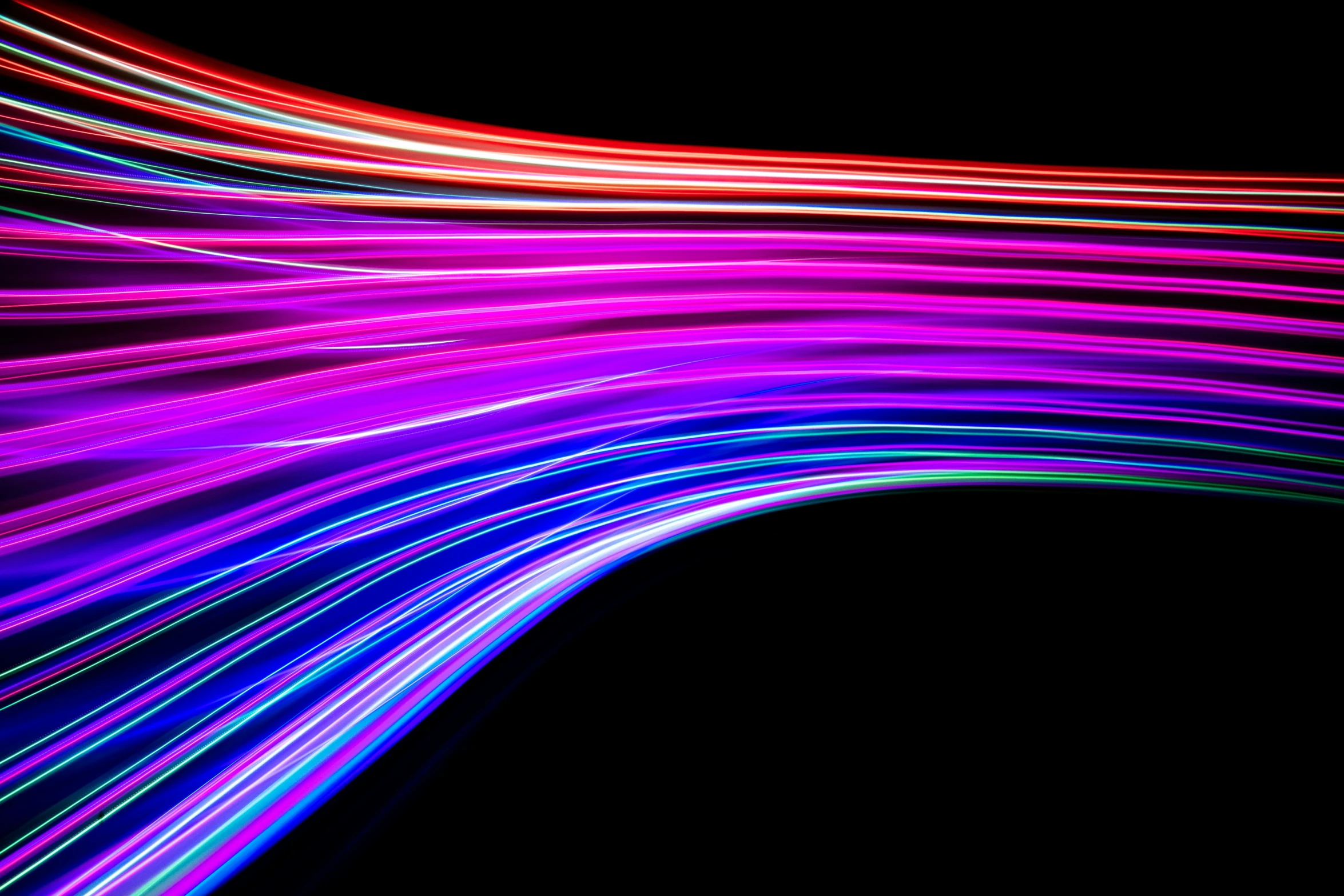 some colorful lines are in the middle of a black background