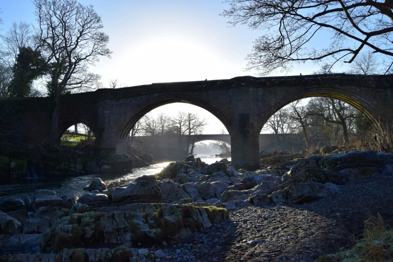 a large bridge over a river surrounded by rocks