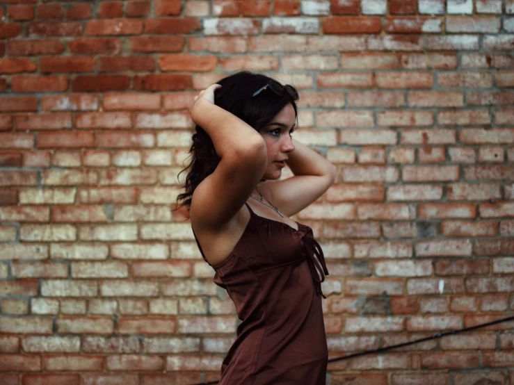 a young lady in an old dress has her arms folded