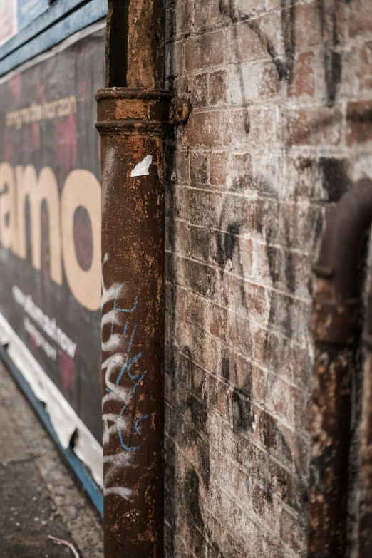 a metal pole leaning against the side of a building