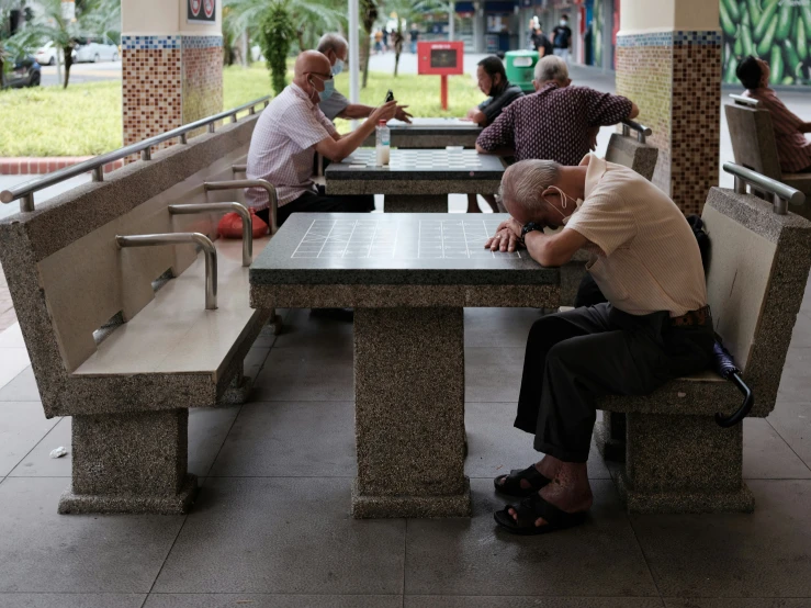 some people sitting around tables in a public area