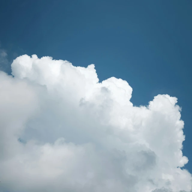 an airplane is flying through a cloudy sky