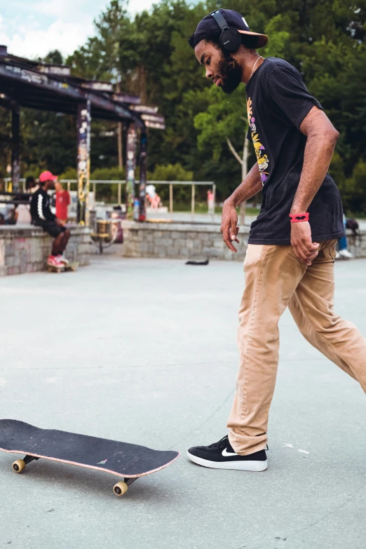a young man walking in front of a skateboard