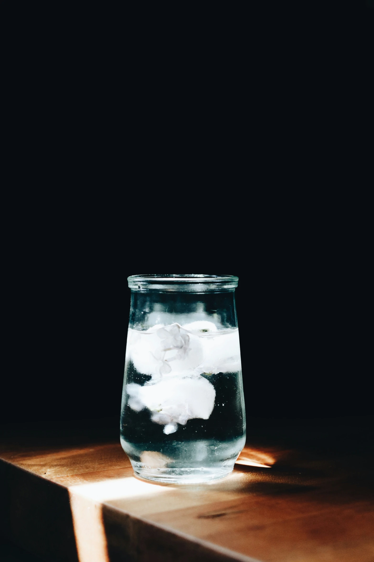a glass filled with ice on a table