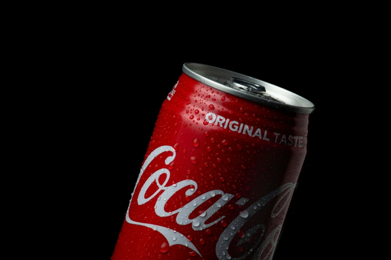 a coca cola can with drops on it