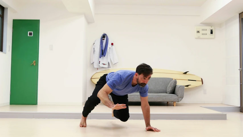 a man stretching in his living room, doing yoga