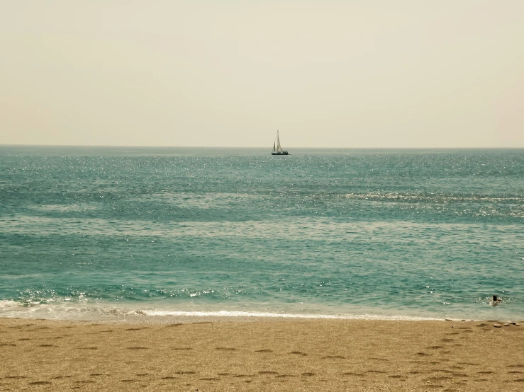 a boat in the ocean on the beach