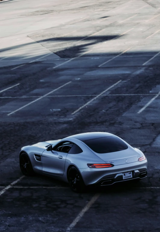 a silver mercedes sports car driving on the road