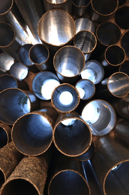 a pile of pipe tubes stacked up together