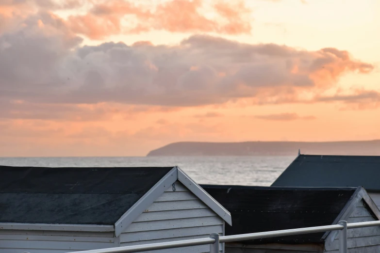 the beach houses are white with black roofs