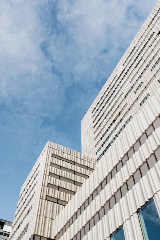 the windows in a building look out on a blue sky