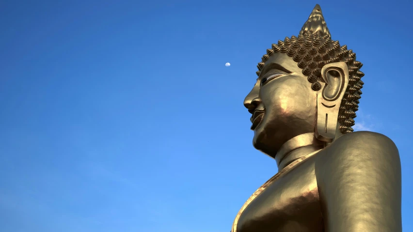 the image of buddha statue is under a blue sky