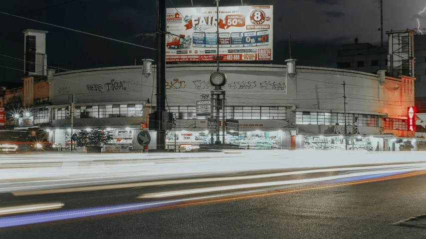 the lights from cars driving through an intersection at night