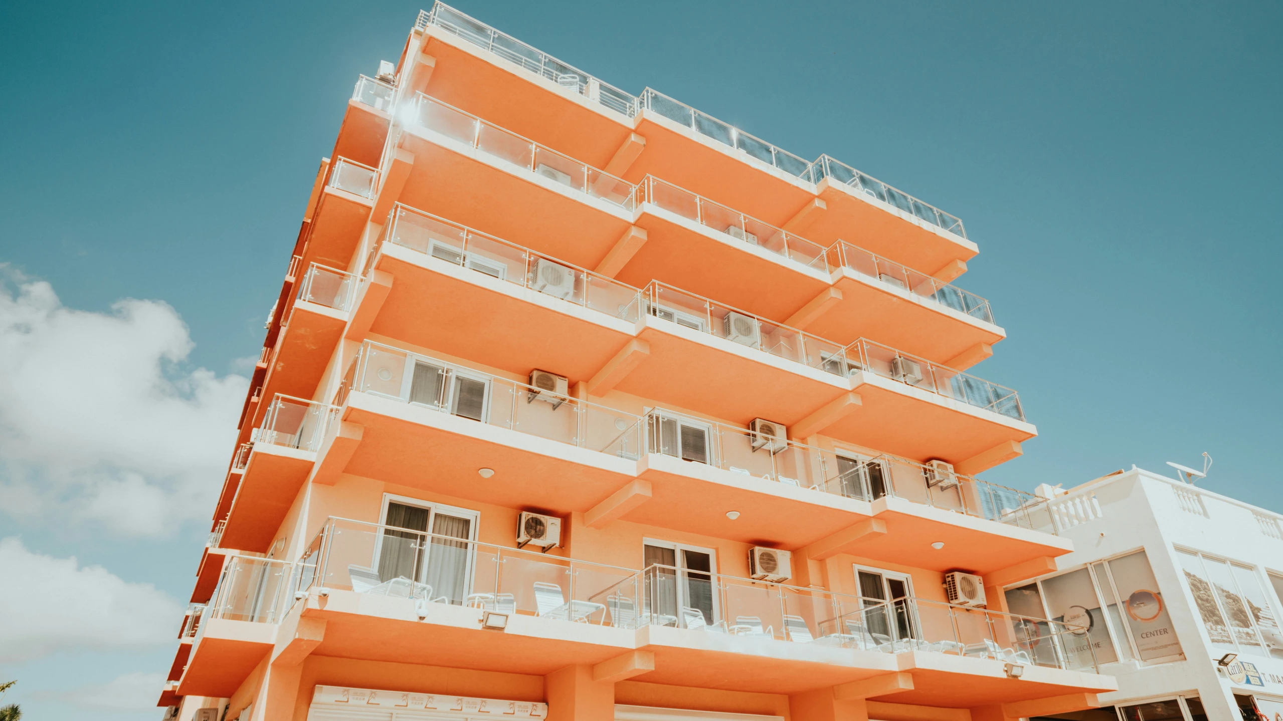 the front view of an orange apartment building