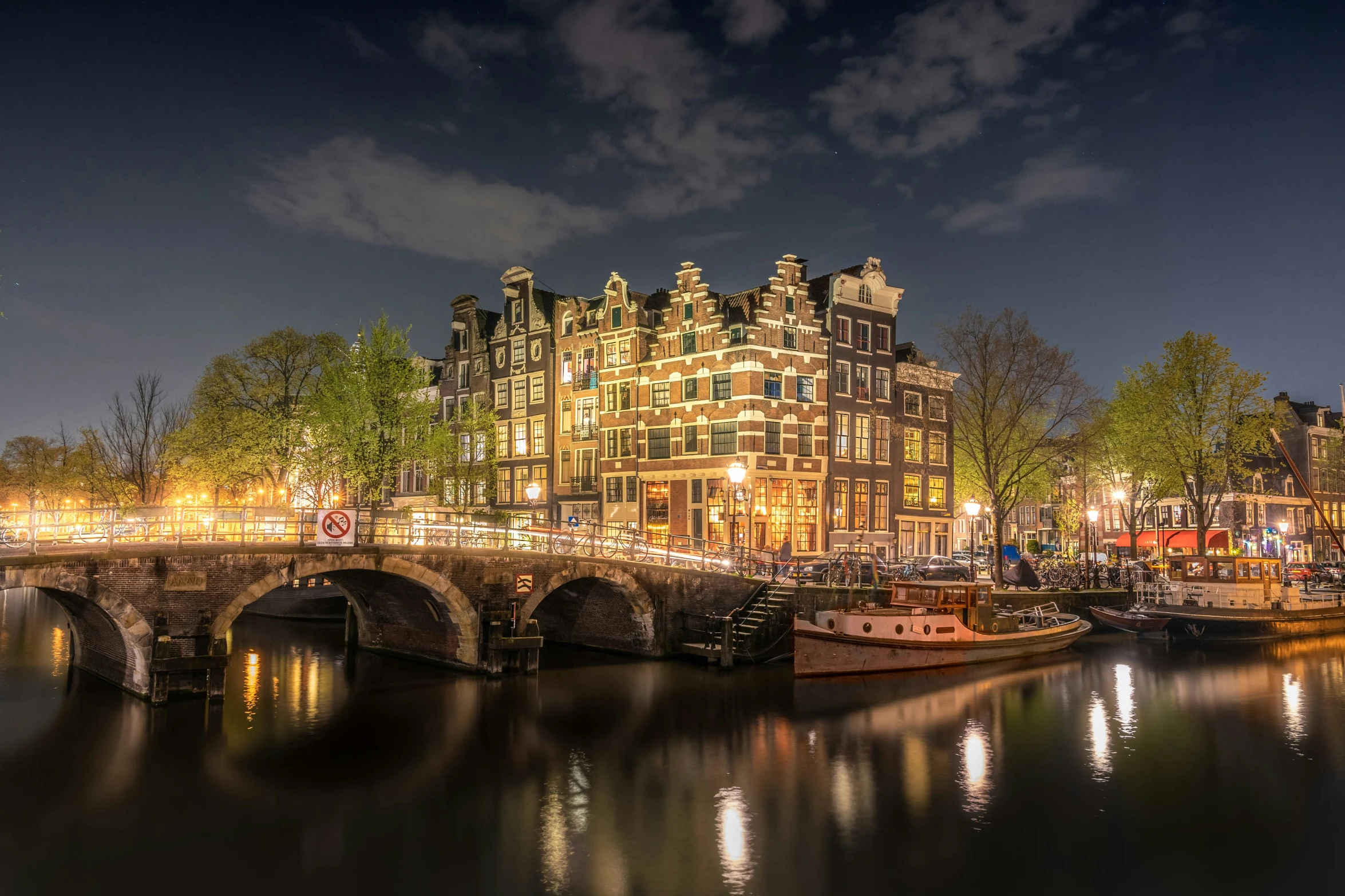 a view of some buildings and bridges at night