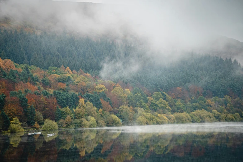 autumn foliage with clouds and water reflecting them