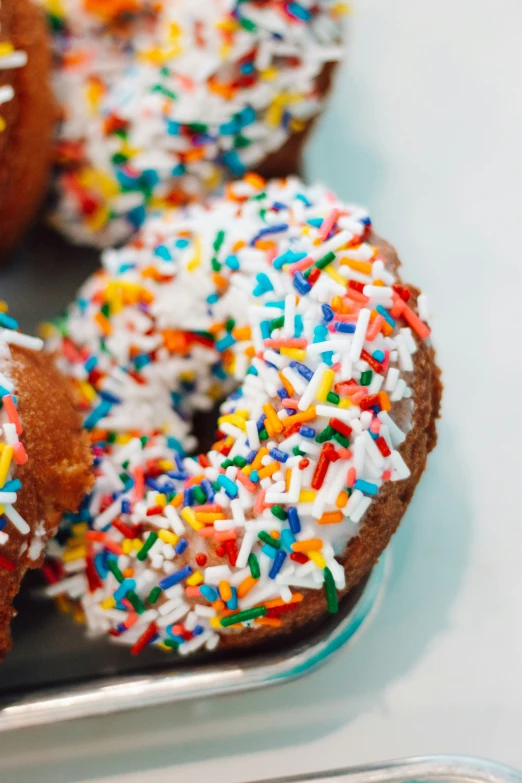 a group of doughnuts with sprinkles are shown