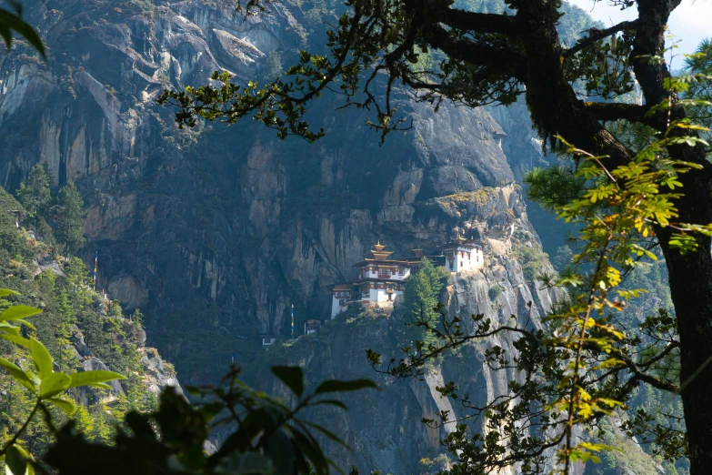 a very tall hill with two buildings on top of it