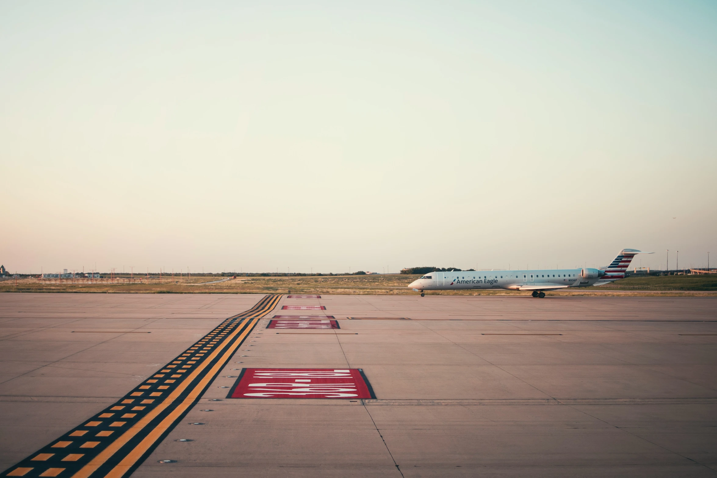 two jet airplanes parked next to each other on a runway