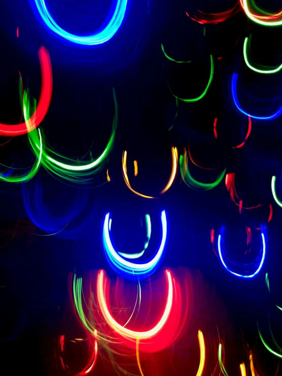 colorful neon colored lights shine in the dark