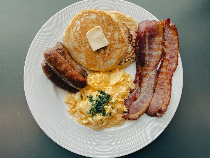 a plate filled with breakfast foods sitting on a counter