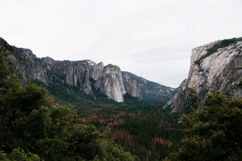 mountains are in the distance with rocks on either side