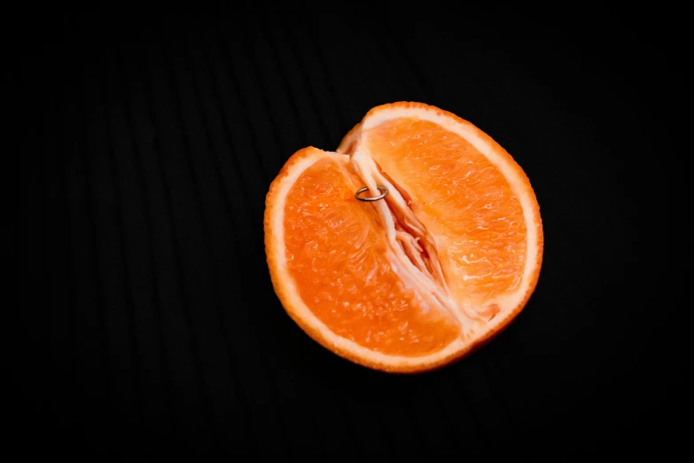 an orange that has just been cut and placed