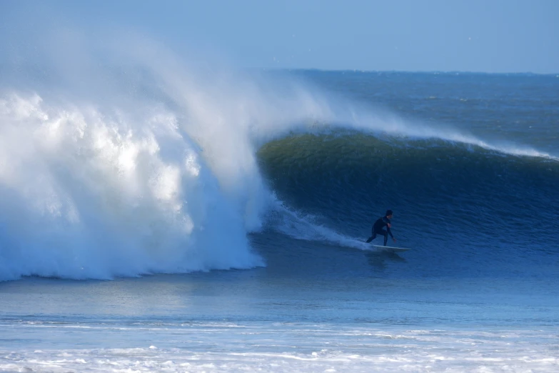 a person on a surfboard is surfing on a wave