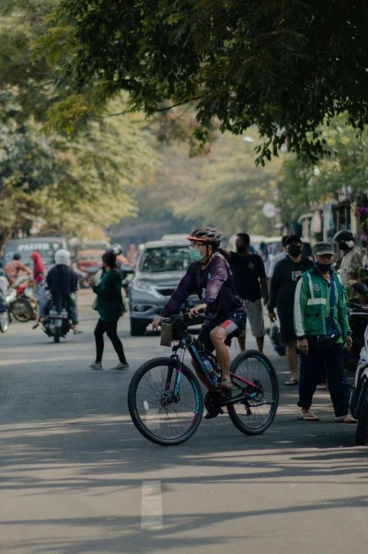 a person riding a bicycle down the street