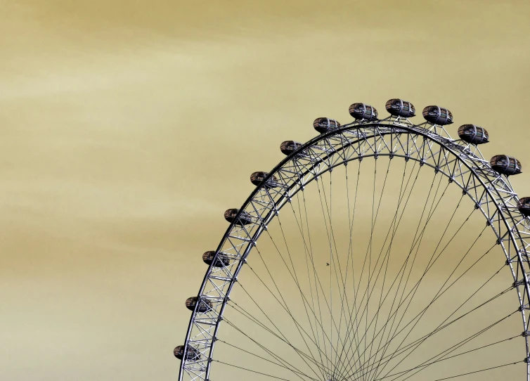 a ferris wheel sitting over a parking lot