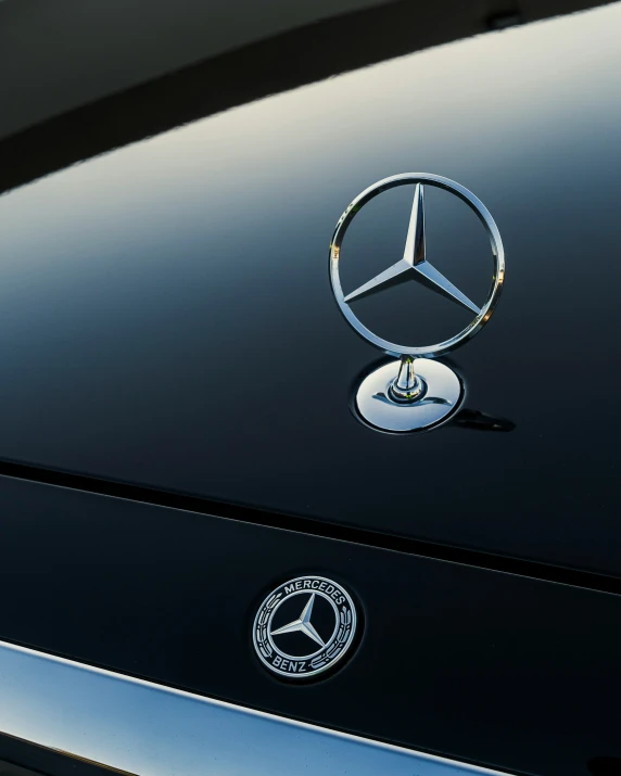 a black mercedes badge on a vehicle