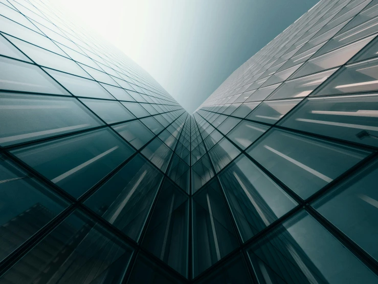 tall glass buildings in front of a bright sky