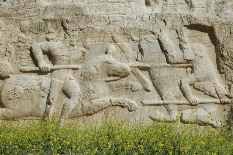 carvings on the side of a stone building in india