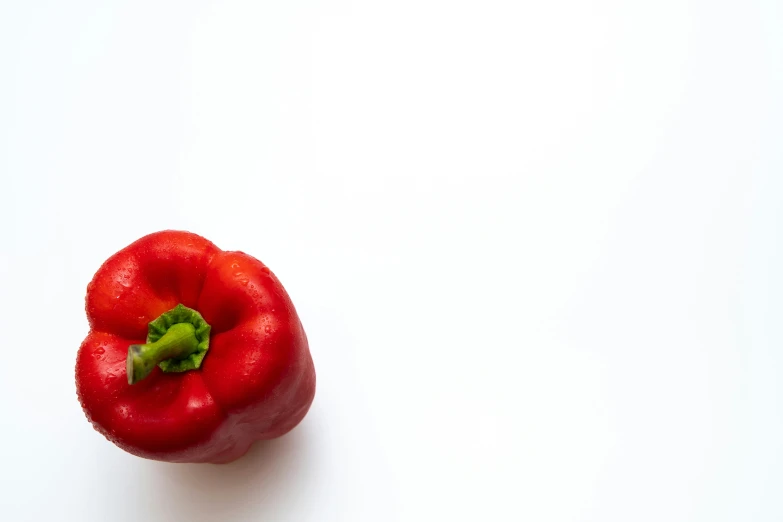 the pepper has a leaf on it, but is almost completely wilting