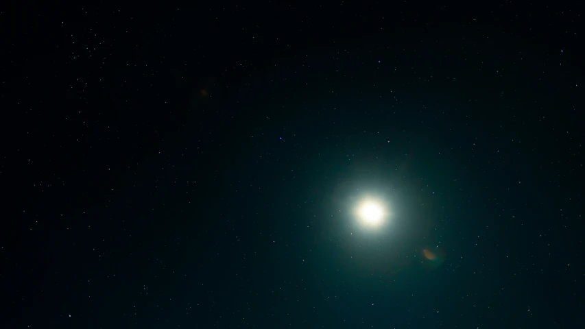 a bright moon against the dark night sky