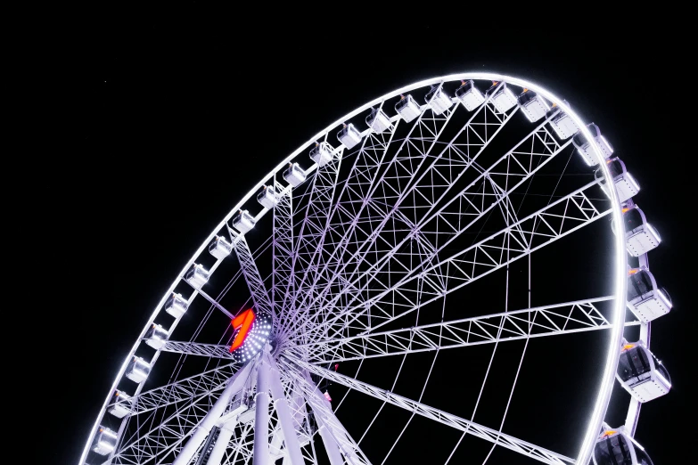 a closeup view of a ferris wheel in the sky