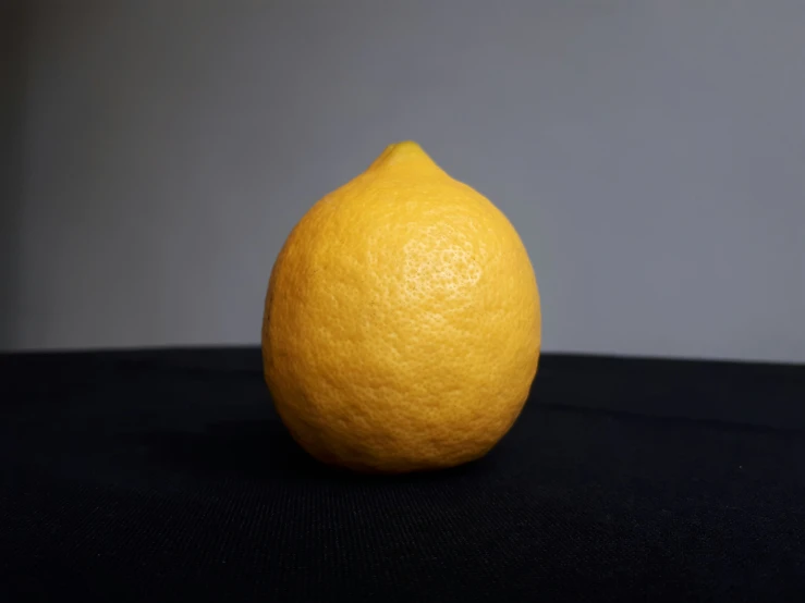 a whole yellow orange on black table