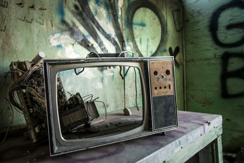 an old television sitting on a table with a paint chip