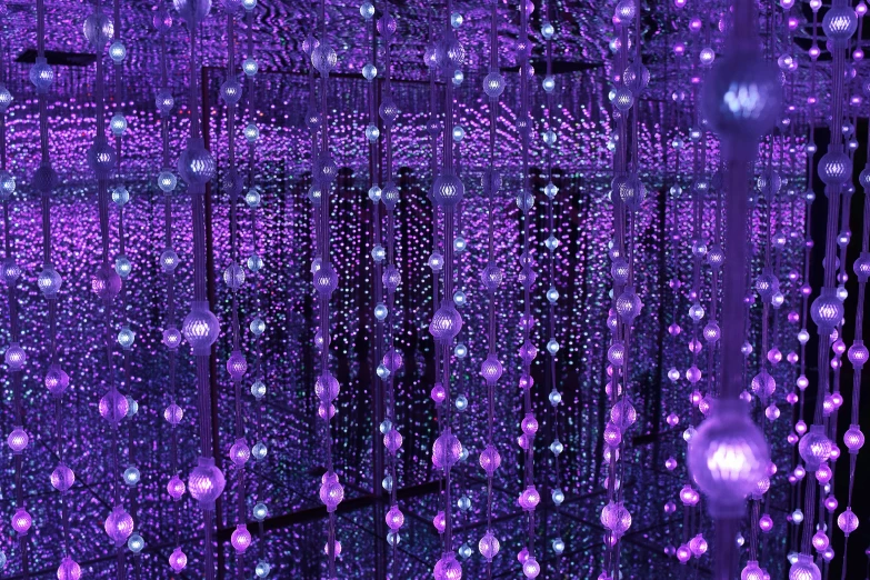 purple lighted balls in the air next to a window