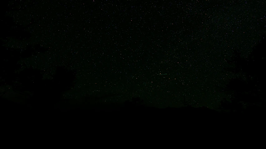 a sky filled with lots of stars and a large building