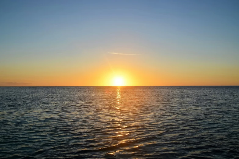 an image of a sunset over the ocean