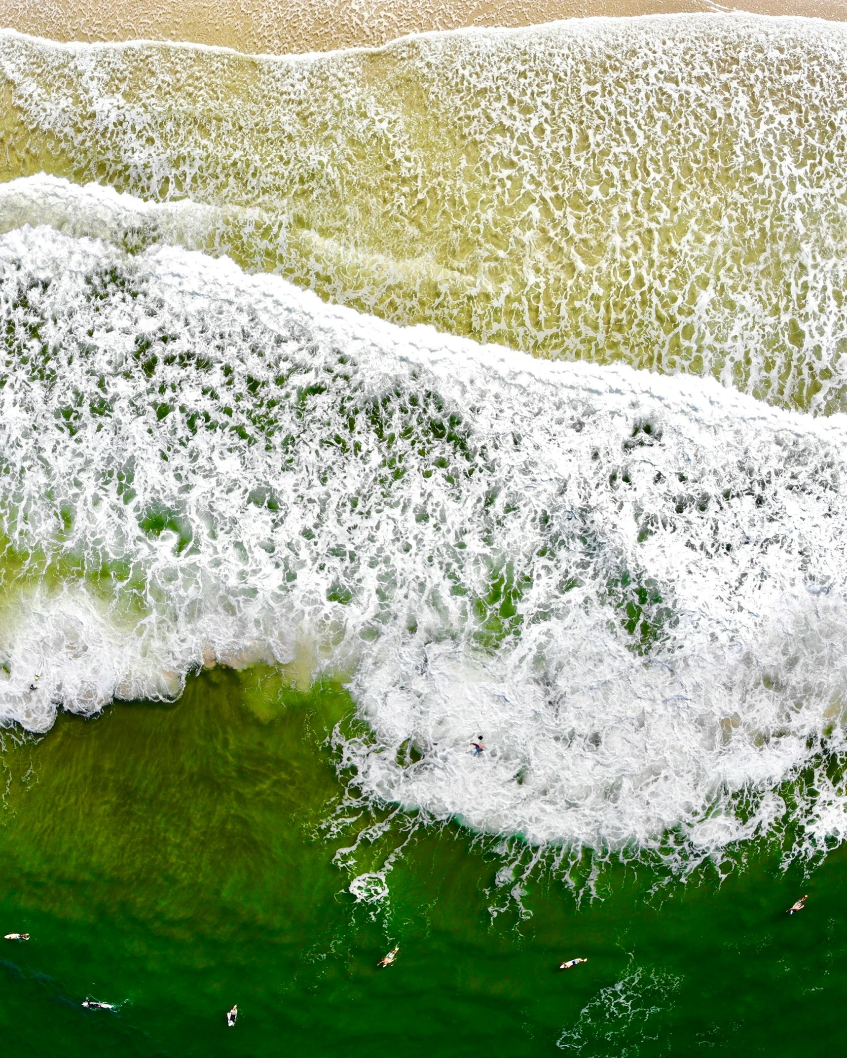 a close up view of waves breaking on a beach