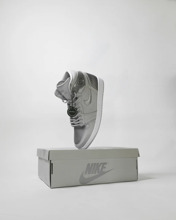 a pair of nike shoes jumping into a shoebox