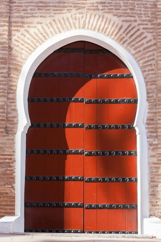 the red door of a building that is made out of wood