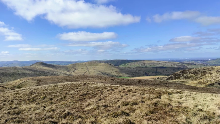 a couple of sheep are on top of a hill