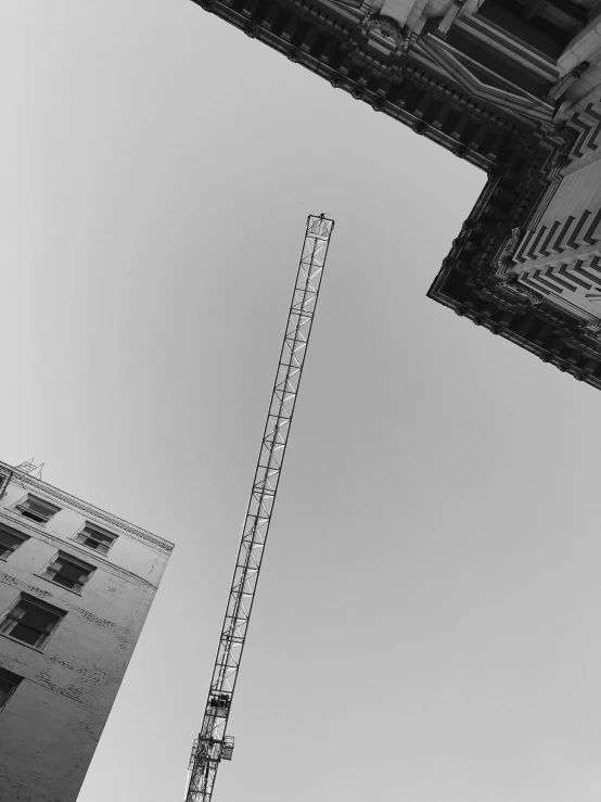 view up into the sky from beneath of a construction crane